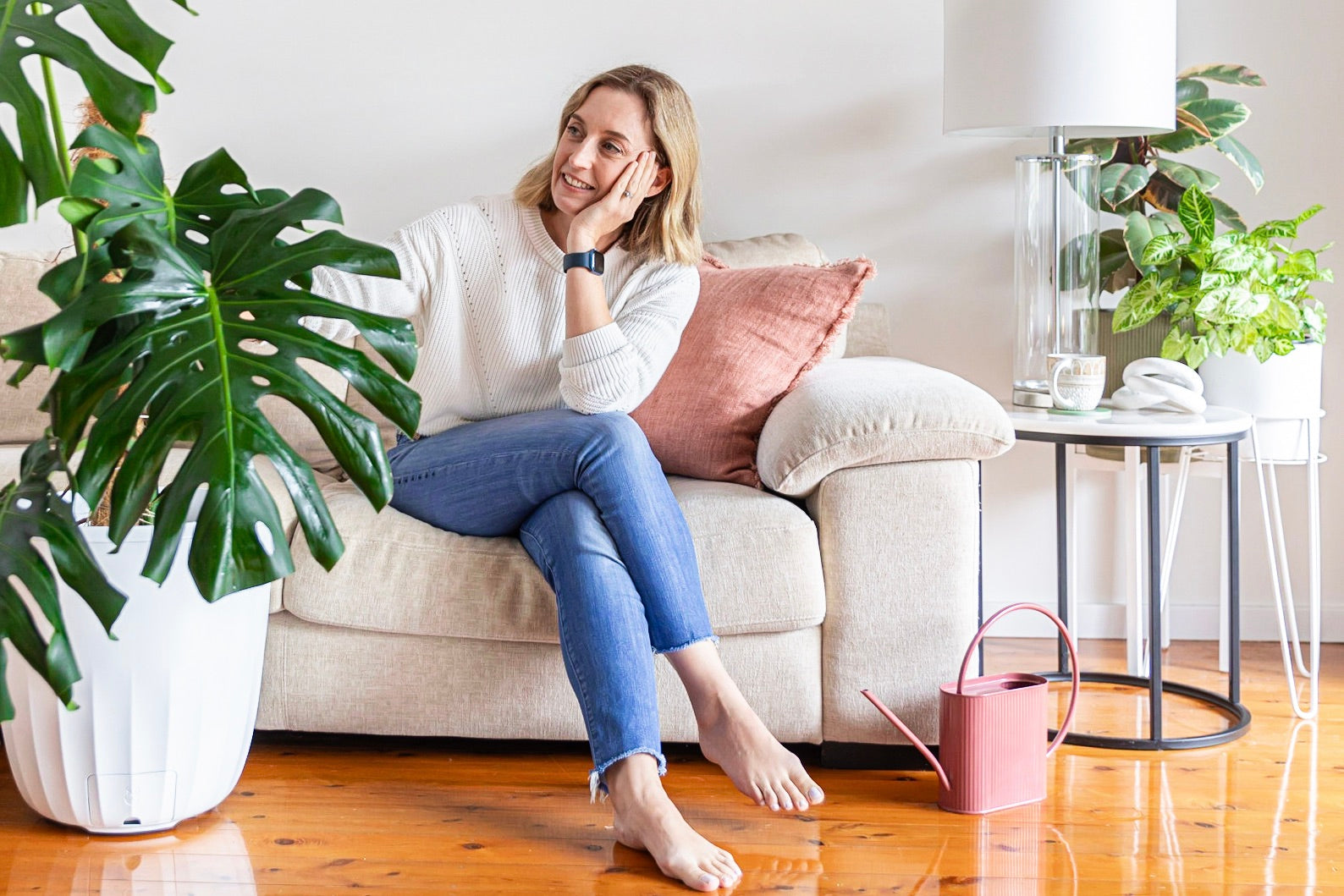 Woman inspecting houseplants for plant pests fungus gnats leaves foliage indoor plants outdoor pot plants pot planter