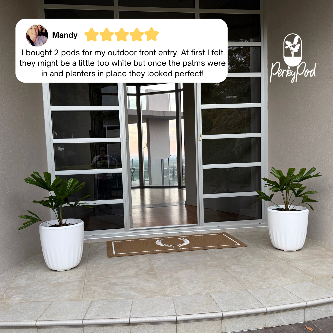 Two PerkyPod planters on a front entrance patio with a glass door in the background. A text overlay features a customer review of five stars explaining that they look perfect with her palms.