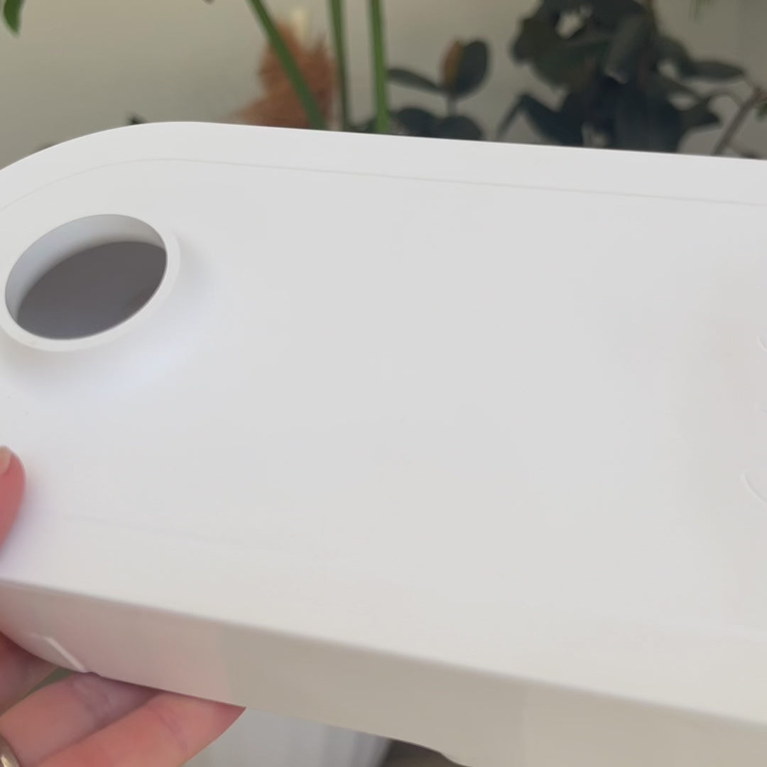 Video showing white PerkyPod plant pot water catchment drawer close up